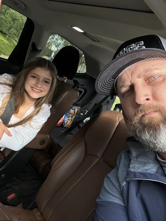 Me and my daughter in the car on the way to the fields.
